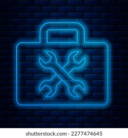 Glowing neon line Toolbox icon isolated on brick wall background. Tool box sign.  Vector