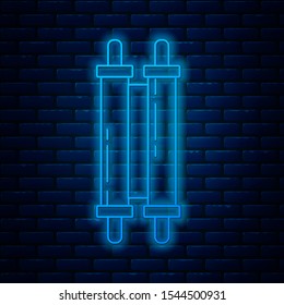 Glowing neon line Torah scroll icon isolated on brick wall background. Jewish Torah in expanded form. Star of David symbol. Old parchment scroll.  Vector Illustration