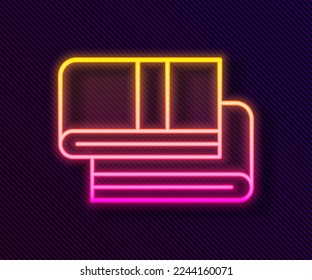 Glowing neon line Towel stack icon isolated on black background.  Vector