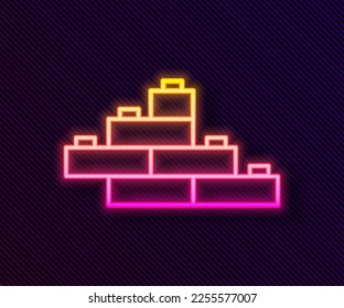 Glowing neon line Toy building block bricks for children icon isolated on black background.  Vector