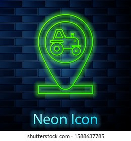 Glowing neon line Tractor and location icon isolated on brick wall background.  Vector Illustration