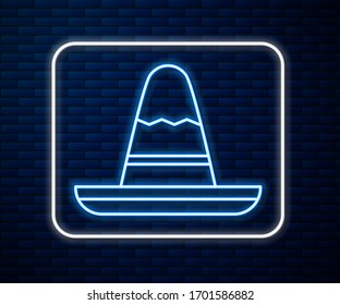 Glowing neon line Traditional mexican sombrero hat icon isolated on brick wall background.  Vector Illustration