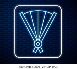 Glowing neon line Traditional paper chinese or japanese folding fan icon isolated on brick wall background.  Vector Illustration