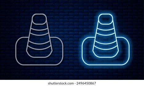 Glowing neon line Traffic cone icon isolated on brick wall background.  Vector