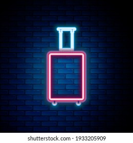 Glowing neon line Travel suitcase icon isolated on brick wall background. Traveling baggage sign. Travel luggage icon. Colorful outline concept. Vector