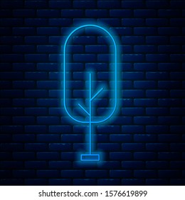Glowing neon line Tree icon isolated on brick wall background. Forest symbol.  Vector Illustration