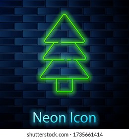 Glowing neon line Tree icon isolated on brick wall background. Forest symbol. Vector Illustration