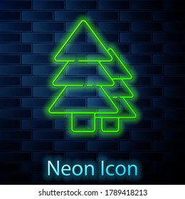 Glowing neon line Tree icon isolated on brick wall background. Forest symbol.  Vector Illustration