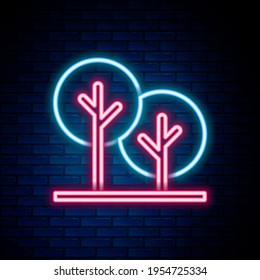 Línea de neón brillante Icono de árbol aislado en fondo de pared de ladrillo. Símbolo de bosque. Concepto de esquema colorido. Vector