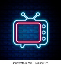 Glowing neon line Tv icon isolated on brick wall background. Television sign. Colorful outline concept. Vector