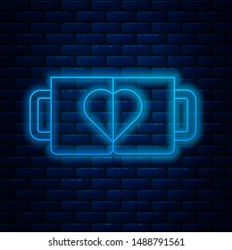 Glowing neon line Two coffee cup and heart icon isolated on brick wall background. Couple coffee for lovers on Valentines Day.  Vector Illustration