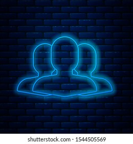 Glowing neon line Users group icon isolated on brick wall background. Group of people icon. Business avatar symbol users profile icon.  Vector Illustration