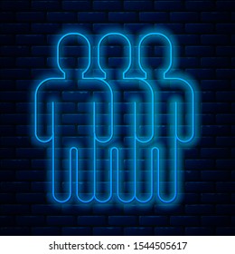 Glowing neon line Users group icon isolated on brick wall background. Group of people icon. Business avatar symbol - users profile icon.  Vector Illustration