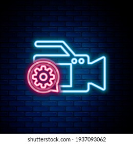 Glowing neon line Video camera and gear icon isolated on brick wall background. Adjusting app, service concept, setting options, maintenance, repair, fixing. Colorful outline concept. Vector