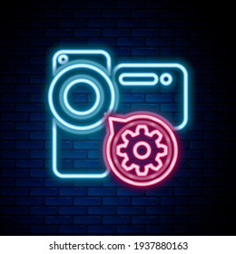 Glowing neon line Video camera and gear icon isolated on brick wall background. Adjusting app, service concept, setting options, maintenance, repair, fixing. Colorful outline concept. Vector