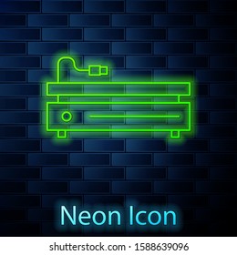 Glowing neon line Video game console icon isolated on brick wall background.  Vector Illustration