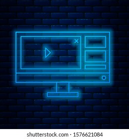 Glowing neon line Video recorder or editor software on computer monitor icon isolated on brick wall background.  Vector Illustration