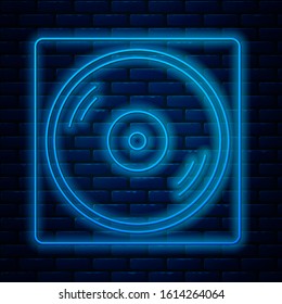 Glowing neon line Vinyl player with a vinyl disk icon isolated on brick wall background.  Vector Illustration