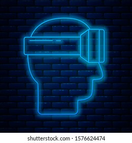 Glowing neon line Virtual reality glasses icon isolated on brick wall background. Stereoscopic 3d vr mask.  Vector Illustration