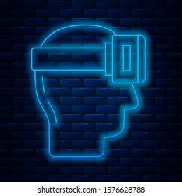 Glowing neon line Virtual reality glasses icon isolated on brick wall background. Stereoscopic 3d vr mask.  Vector Illustration