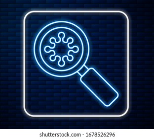 Glowing neon line Virus under magnifying glass icon isolated on brick wall background. Corona virus 2019-nCoV. Bacteria and germs, microbe, fungi.  Vector Illustration