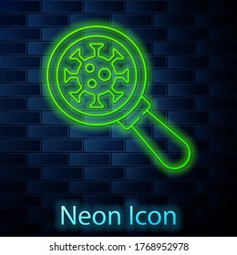 Glowing neon line Virus under magnifying glass icon isolated on brick wall background. Corona virus 2019-nCoV. Bacteria and germs, microbe, fungi. Vector.