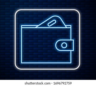 Glowing neon line Wallet with stacks paper money cash icon isolated on brick wall background. Purse icon. Cash savings symbol.  Vector Illustration