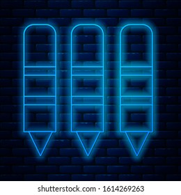 Glowing neon line Wax crayons for drawing icon isolated on brick wall background.  Vector Illustration