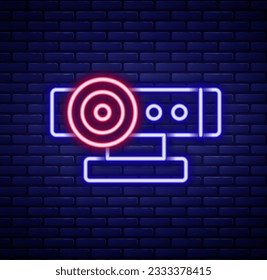 Glowing neon line Web camera icon isolated on brick wall background. Chat camera. Webcam icon. Colorful outline concept. Vector