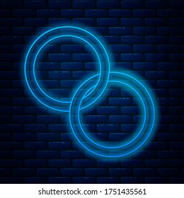 Glowing neon line Wedding rings icon isolated on brick wall background. Bride and groom jewelry sign. Marriage symbol. Diamond ring.  Vector