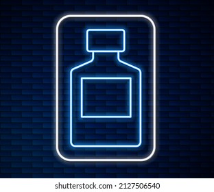 Glowing neon line Whiskey bottle icon isolated on brick wall background.  Vector