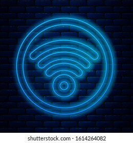 Glowing neon line Wi-Fi wireless internet network symbol icon isolated on brick wall background.  Vector Illustration