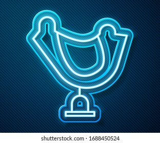 Glowing neon line Wild west saddle icon isolated on blue background.  Vector Illustration