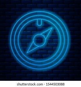 Glowing neon line Wind rose icon isolated on brick wall background. Compass icon for travel. Navigation design.  Vector Illustration