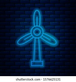 Glowing neon line Wind turbine icon isolated on brick wall background. Wind generator sign. Windmill for electric power production.  Vector Illustration