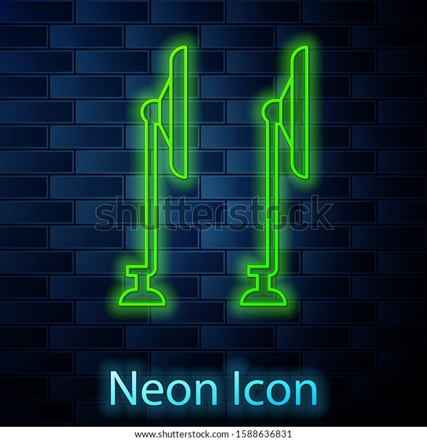 Glowing neon line Windscreen wiper\
icon isolated on brick wall background.  Vector\
Illustration