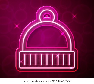Glowing neon line Winter hat icon isolated on red background.  Vector