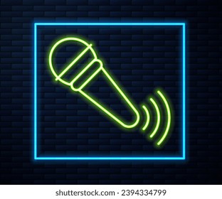 Glowing neon line Wireless microphone icon isolated on brick wall background. On air radio mic microphone. Speaker sign.  Vector