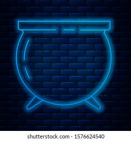 Glowing neon line Witch cauldron icon isolated on brick wall background. Happy Saint Patricks day.  Vector Illustration