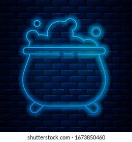 Glowing neon line Witch cauldron icon isolated on brick wall background. Happy Halloween party.  Vector Illustration