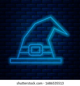 Glowing neon line Witch hat icon isolated on brick wall background. Happy Halloween party.  Vector Illustration