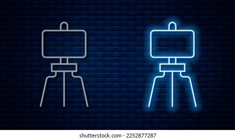 Glowing neon line Wood easel or painting art board icon isolated on brick wall background.  Vector