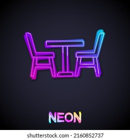 Glowing neon line Wooden table with chair icon isolated on black background.  Vector