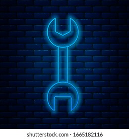 Glowing neon line Wrench spanner icon isolated on brick wall background.  Vector Illustration