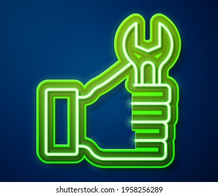 Glowing neon line Wrench spanner icon isolated on blue background.  Vector