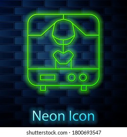 Glowing neon line X-ray machine icon isolated on brick wall background. Vector Illustration