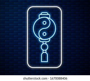 Glowing neon line Yin Yang symbol of harmony and balance icon isolated on brick wall background.  Vector Illustration