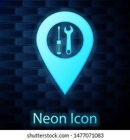 Glowing neon Location with crossed screwdriver and wrench tools icon isolated on brick wall background. Pointer settings symbol.  Vector Illustration