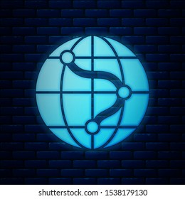 Glowing neon Location on the globe icon isolated on brick wall background. World or Earth sign.  Vector Illustration