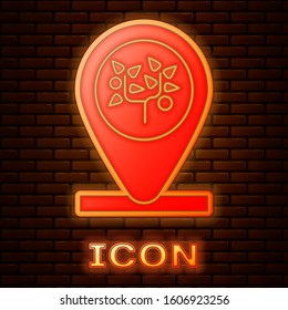 Glowing neon Location and tree icon isolated on brick wall background.  Vector Illustration